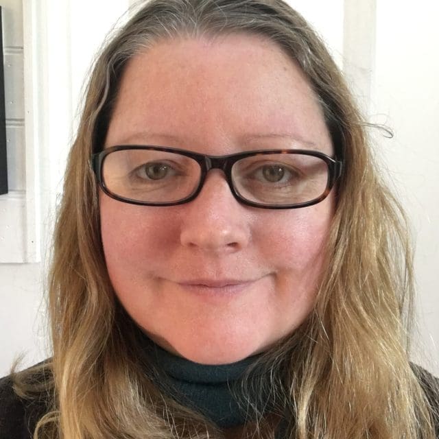 Photo of Heidi Ball, Professional Writing Academy Moderator, long mousy brown hair and glasses.